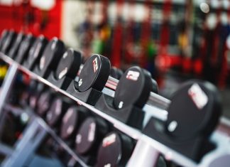Best Gyms in Newark for Every Budget – 2026 Guide Close-up view of dumbbells in a modern gym setting, emphasizing fitness and training.