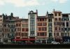 Best Neighborhoods to Live in Bayonne, NJ (2026 Guide) Charming traditional buildings along the Nive River in Bayonne, France, showcasing unique Basque architecture.