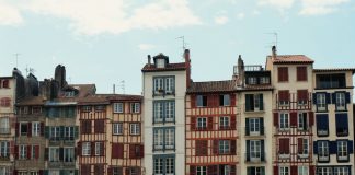 Best Neighborhoods to Live in Bayonne, NJ (2026 Guide) Charming traditional buildings along the Nive River in Bayonne, France, showcasing unique Basque architecture.