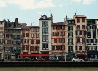 Best Neighborhoods to Live in Bayonne, NJ (2026 Guide) Charming traditional buildings along the Nive River in Bayonne, France, showcasing unique Basque architecture.