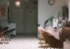 A cozy and modern nail salon interior featuring stylish chairs and nail polish display.