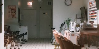 A cozy and modern nail salon interior featuring stylish chairs and nail polish display.