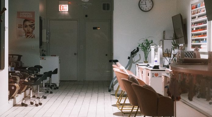Your Go-To Guide for the Best Salons and Barbershops in West New York (2026) A cozy and modern nail salon interior featuring stylish chairs and nail polish display.