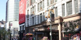Daytime view of Macy's storefront in New York City, showcasing urban architecture and bustling streets.