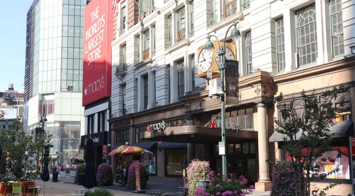 Daytime view of Macy's storefront in New York City, showcasing urban architecture and bustling streets.