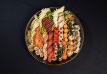 Vibrant sushi platter featuring assorted rolls and fresh sashimi beautifully arranged.