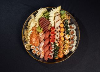 Vibrant sushi platter featuring assorted rolls and fresh sashimi beautifully arranged.