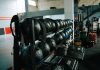 Well-equipped indoor gym featuring kettlebells, weights, and workout gear, perfect for fitness enthusiasts.
