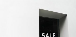 BREAKING: 99¢ Dream on Newark Ave to Close for Mixed-Use Project A minimalist black and white image of a sale sign on a store window with ample negative space.