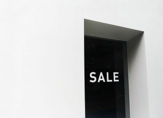 BREAKING: 99¢ Dream on Newark Ave to Close for Mixed-Use Project A minimalist black and white image of a sale sign on a store window with ample negative space.