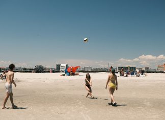 A lively beach volleyball game under a clear sky at Cape May, New Jersey.