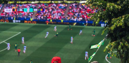 Engaging view of soccer fans enjoying a live match at a stadium in Langford, BC, Canada.