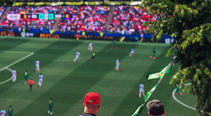 Engaging view of soccer fans enjoying a live match at a stadium in Langford, BC, Canada.