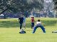 Group of kids enjoying a soccer game on a sunny day in the park.