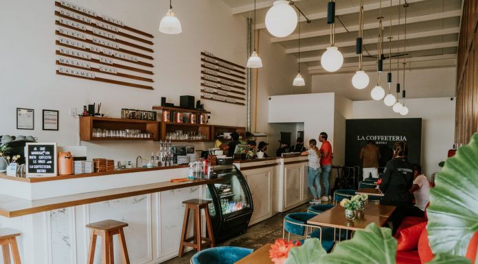 Inviting coffee shop with modern design, customers enjoying drinks, and stylish decor.
