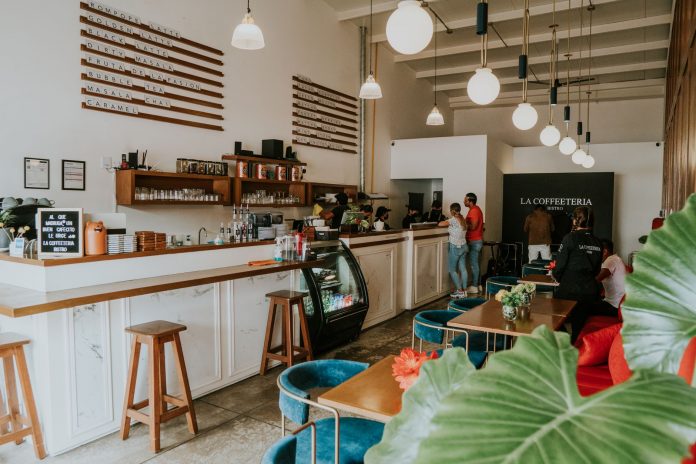 Inviting coffee shop with modern design, customers enjoying drinks, and stylish decor.
