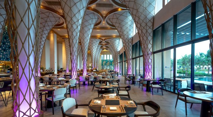 Spacious modern restaurant interior with unique architectural design and ambient lighting.