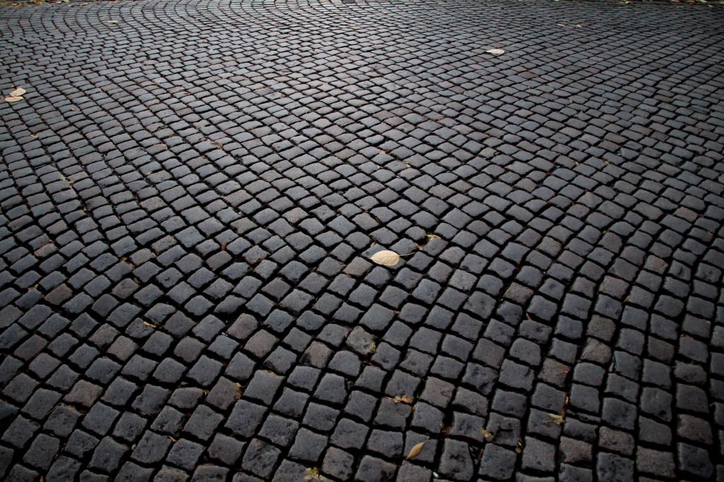 Detailed view of cobblestone pavement pattern in Katowice, Poland, highlighting its historic charm.