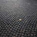 Detailed view of cobblestone pavement pattern in Katowice, Poland, highlighting its historic charm.