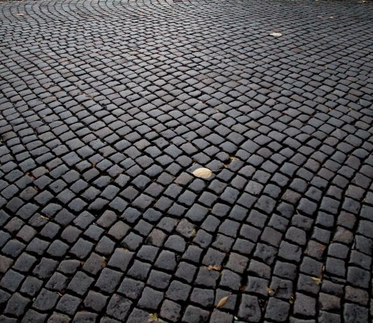 Detailed view of cobblestone pavement pattern in Katowice, Poland, highlighting its historic charm.