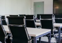 BREAKING: Jersey City Health Department Presents $8.2M Budget Amid Layoffs Sleek modern conference room with black chairs and white desks, suitable for business meetings.