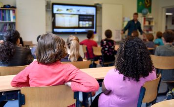 BREAKING: Jersey City School Board to Vote on Superintendent’s $1.5M Contract Students attentively watching a lesson on a smart board in a colorful Dutch classroom.