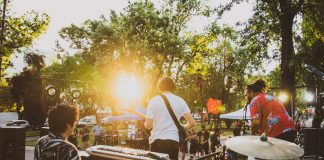 BREAKING: July Live Music Series Returns to Jersey City Parks Musicians performing live at a summer outdoor concert during sunset in a park.