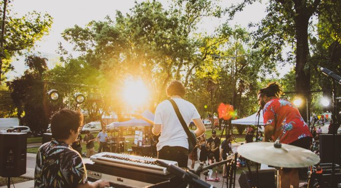 BREAKING: July Live Music Series Returns to Jersey City Parks Musicians performing live at a summer outdoor concert during sunset in a park.