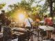 BREAKING: July Live Music Series Returns to Jersey City Parks Musicians performing live at a summer outdoor concert during sunset in a park.