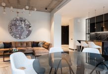 Spacious modern living room with chic decor and open kitchen setup. Perfect for interior design inspiration.