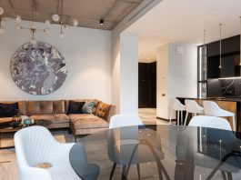 Spacious modern living room with chic decor and open kitchen setup. Perfect for interior design inspiration.