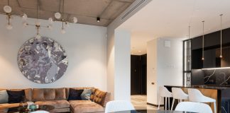 Spacious modern living room with chic decor and open kitchen setup. Perfect for interior design inspiration.