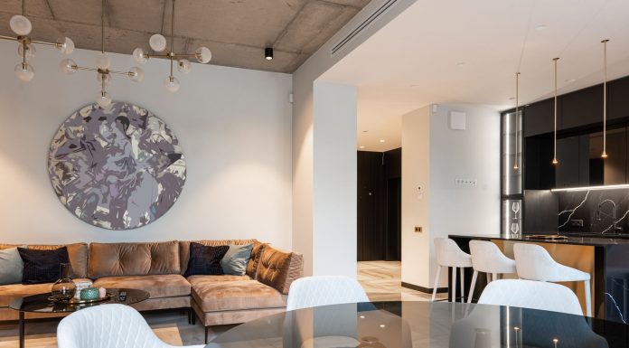 Spacious modern living room with chic decor and open kitchen setup. Perfect for interior design inspiration.