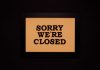 Black-framed 'Sorry We're Closed' sign against a dark backdrop, ideal for business themes.