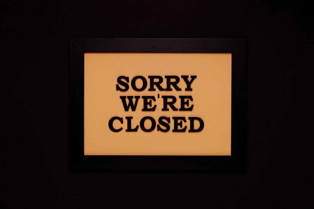 Black-framed 'Sorry We're Closed' sign against a dark backdrop, ideal for business themes.