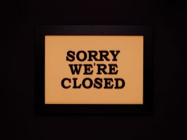 Black-framed 'Sorry We're Closed' sign against a dark backdrop, ideal for business themes.