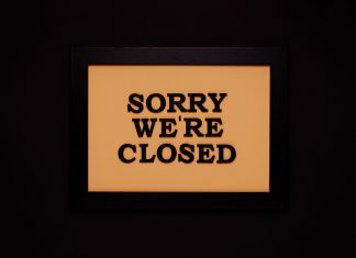 Black-framed 'Sorry We're Closed' sign against a dark backdrop, ideal for business themes.
