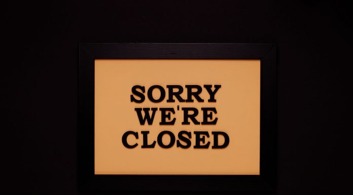Black-framed 'Sorry We're Closed' sign against a dark backdrop, ideal for business themes.