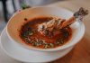 Delicious lamb shank soup garnished with fresh herbs, perfect for a cozy meal.