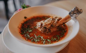 BREAKING: Springbone Kitchen Opens Hoboken Location on Washington Street Delicious lamb shank soup garnished with fresh herbs, perfect for a cozy meal.