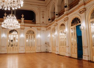 Elegant concert hall with chandeliers and ornate decor in Maribor, Slovenia.