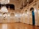 Elegant concert hall with chandeliers and ornate decor in Maribor, Slovenia.