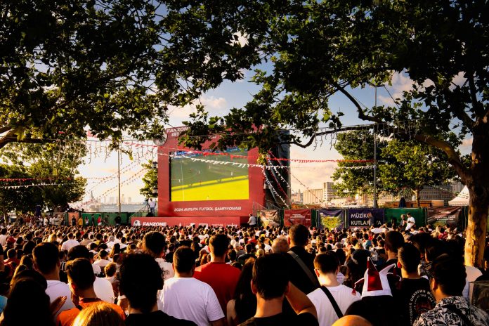 breaking-world-cup-final-watch-party-among-this-we Crowd gathered in İstanbul park watching Euro football on big screen. Energetic summer atmosphere.