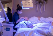 Ethos Aesthetics Hosts VIP Summer Event in Hoboken Patients receiving LED light therapy and facial treatment in a spa setting.