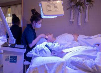 Patients receiving LED light therapy and facial treatment in a spa setting.