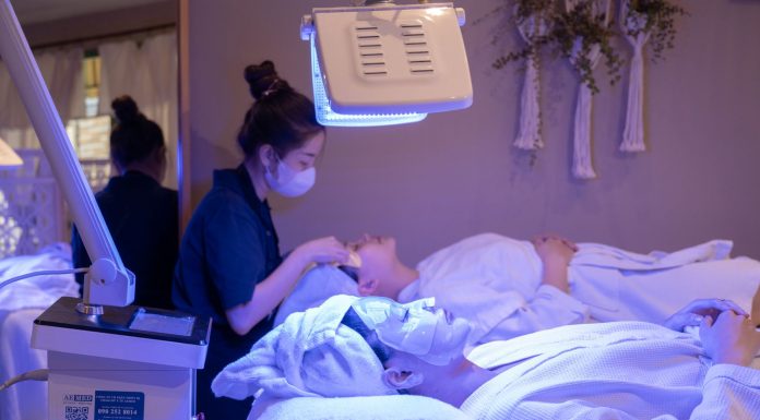 Patients receiving LED light therapy and facial treatment in a spa setting.
