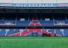 Gardener working on the field at Parc des Princes stadium, Paris. Vibrant and iconic sports venue.