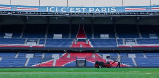 Gardener working on the field at Parc des Princes stadium, Paris. Vibrant and iconic sports venue.