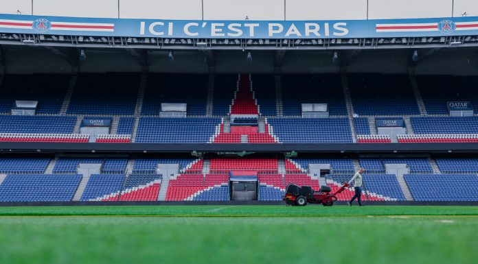 Gardener working on the field at Parc des Princes stadium, Paris. Vibrant and iconic sports venue.