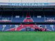 Gardener working on the field at Parc des Princes stadium, Paris. Vibrant and iconic sports venue.